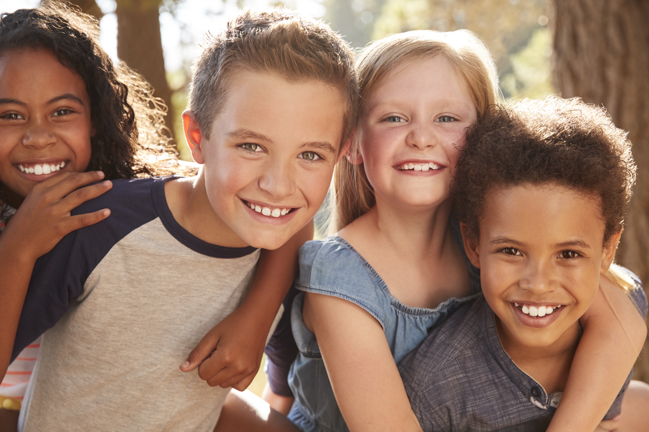 Portrait Of Children With Friends On Hiking Adventure In Woods